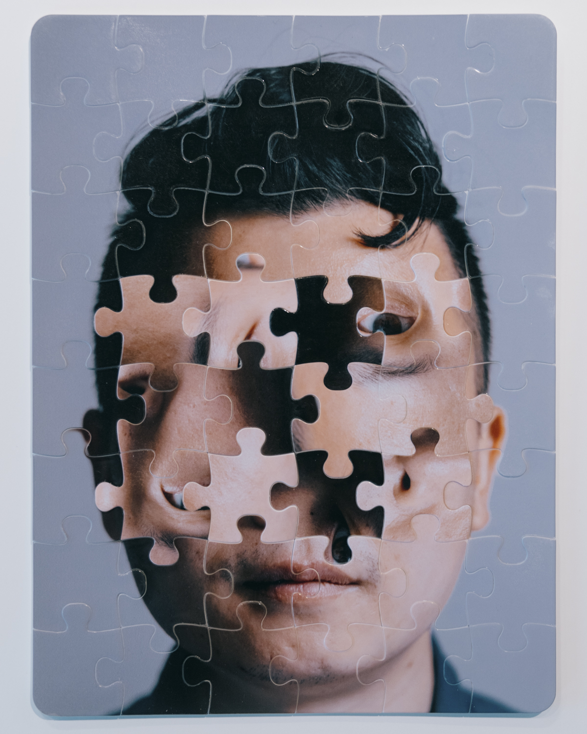 A man's face made up of puzzle pieces