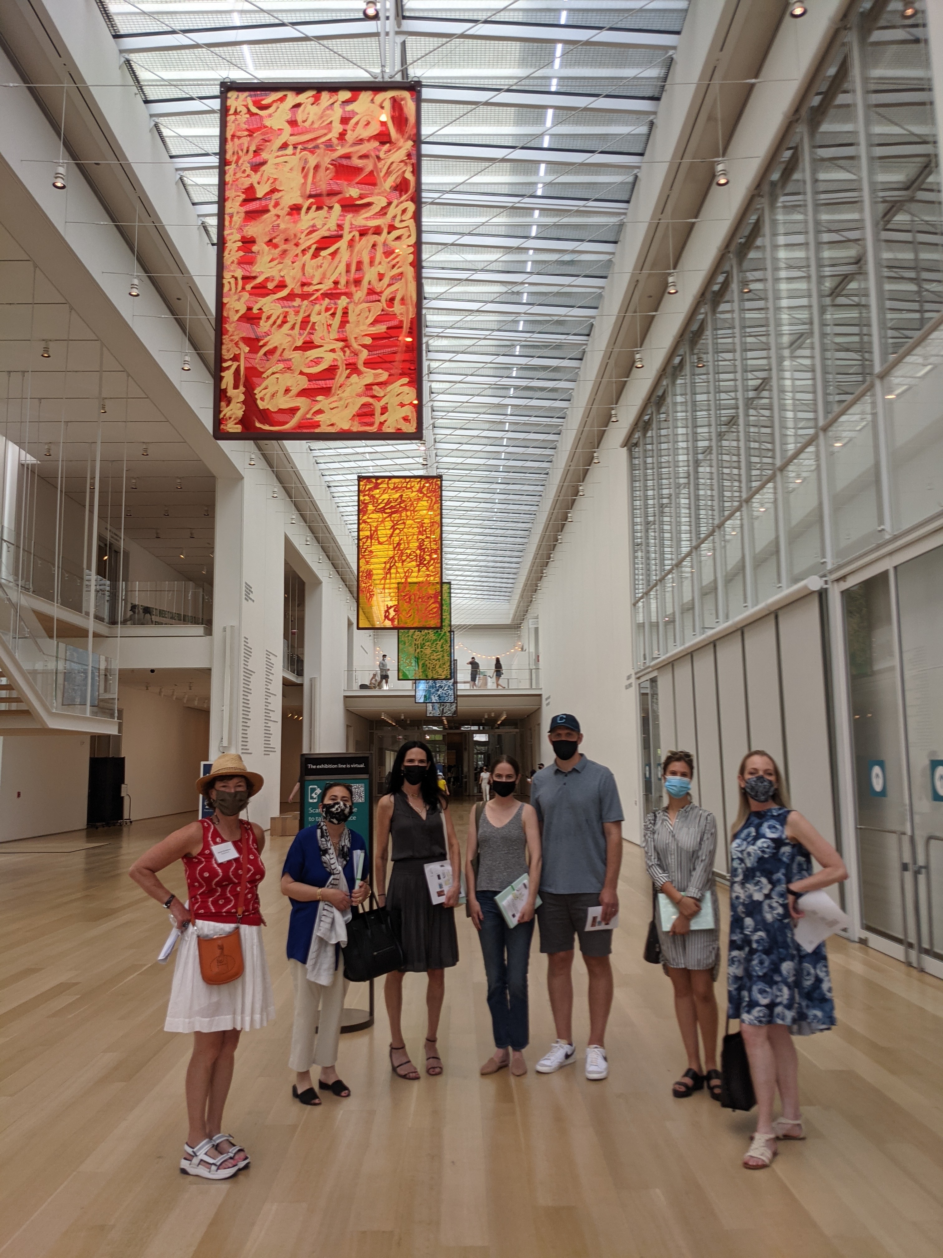 SCA members stand in a large atrium space in a museum.